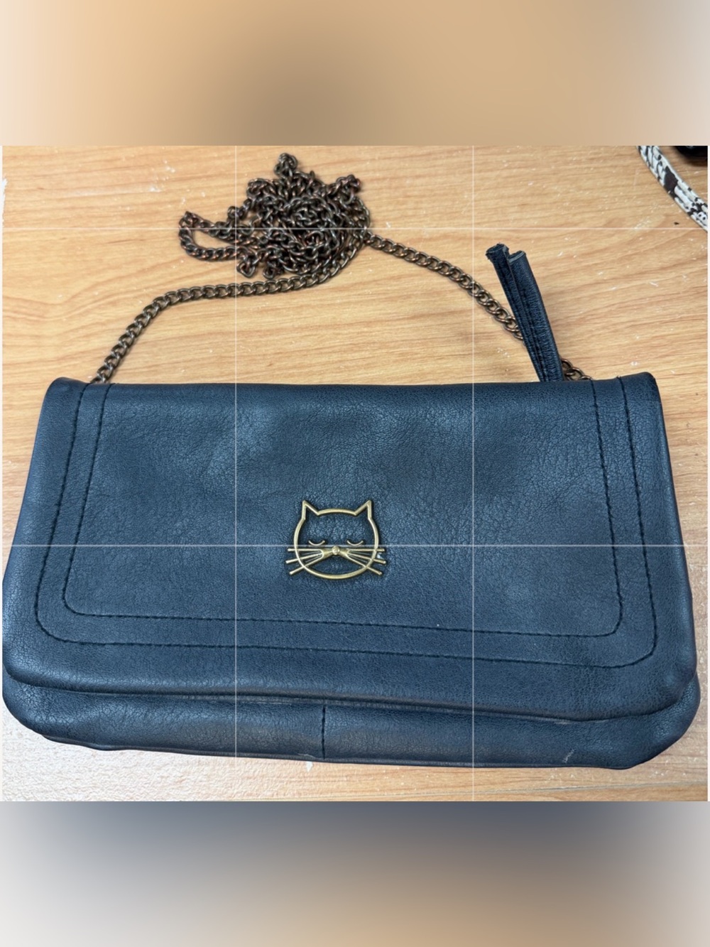 Chic Black Crossbody Clutch with Gold Cat Emblem